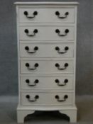 A Georgian style painted narrow chest of six drawers with serpentine front on shaped bracket feet.