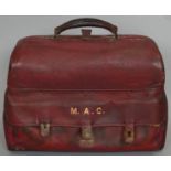 A lockable red leather travelling men's vanity case. Contains ivory glove stretchers, silver