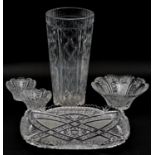 A collection of cut crystal and glass items. Including a large cut crystal vase with geometric