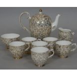 A Imperial bone china 24 carat gold plated floral design coffee set with, coffee pot, six cups,