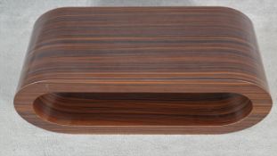 A contemporary laminated zebra wood effect low table. H.36 L.90.5 W.34.5cm