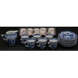 A Chinese blue and white six coffee cups and saucers with jug, decorated with flowers and people,