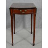 A 19th century mahogany Pembroke table with ebony and satinwood stringing raised on slender square