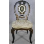 A Victorian papier mache side chair hand decorated with floral gilt and inlaid coloured glass in