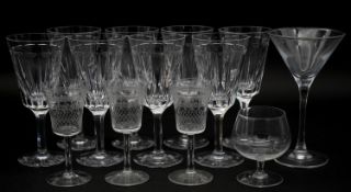 A collection of thirteen glasses to include eight wine glasses with faceted design along with