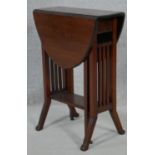 A small Edwardian mahogany Sutherland table with pierced end supports on splay feet. H.65 L.71 W.