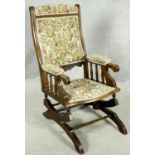 A late 19th century carved mahogany framed American rocking chair with spring mechanism. H.100 W.