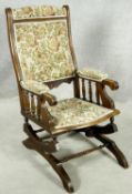 A late 19th century carved mahogany framed American rocking chair with spring mechanism. H.100 W.