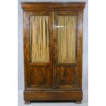 A 19th century French Louis Philippe burr walnut wardrobe with glazed and panelled doors enclosing