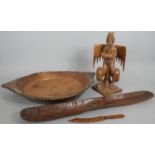 A collection of carved wooden items. Including an oriental carved statue of a deity, a two handled