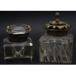 Two antique glass inkwells. One with a faceted cube design and glass top and the other with a