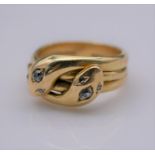 A Victorian yellow metal (tested 18ct) double headed cross over snake ring. Each of the snakes heads