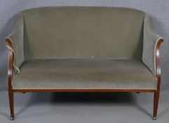 An Edwardian mahogany and satinwood strung upholstered two seater tub shaped canape. H.85 W.130 D.