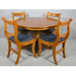 A Regency style yew wood dining table and matching bar back dining chairs. Table H.77 W.107cm Chairs