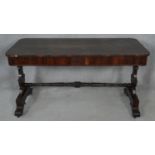 A 19th century rosewood library table with frieze drawers on stretchered carved supports. H.74 L.138