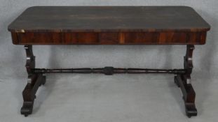 A 19th century rosewood library table with frieze drawers on stretchered carved supports. H.74 L.138