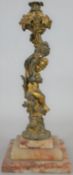 A 19th century gilt bronze candlestick the stem in the form of a cherub seated among vines raised on