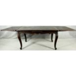 A C.1900 French oak draw leaf extending dining table with parquetry inlaid top raised on carved