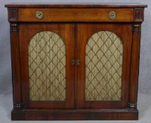 A Regency rosewood chiffonier with frieze drawer above arched metal grille doors and pleated silk