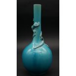 A fine turquoise glazed Chinese porcelain bottle vase with relief decoration of a dragon wrapped