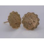 A pair of 15 carat yellow gold engraved scalloped edge stud earrings. Engraved with a floral motif