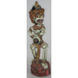 An Indonesian painted tribal carved wooden Keris holder in the form of the monkey god Hanuman. H.