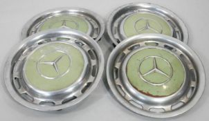 A set of four vintage chrome Mercedes wheel hub caps. H.40cm