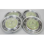 A set of four vintage chrome Mercedes wheel hub caps. H.40cm