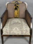 An early 19th century Chinoiserie lacquered bergere armchair with caned back and sides. H.80cm (