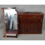 A 19th century mahogany mirror backed sideboard with arched plate above drawers and panel doors on