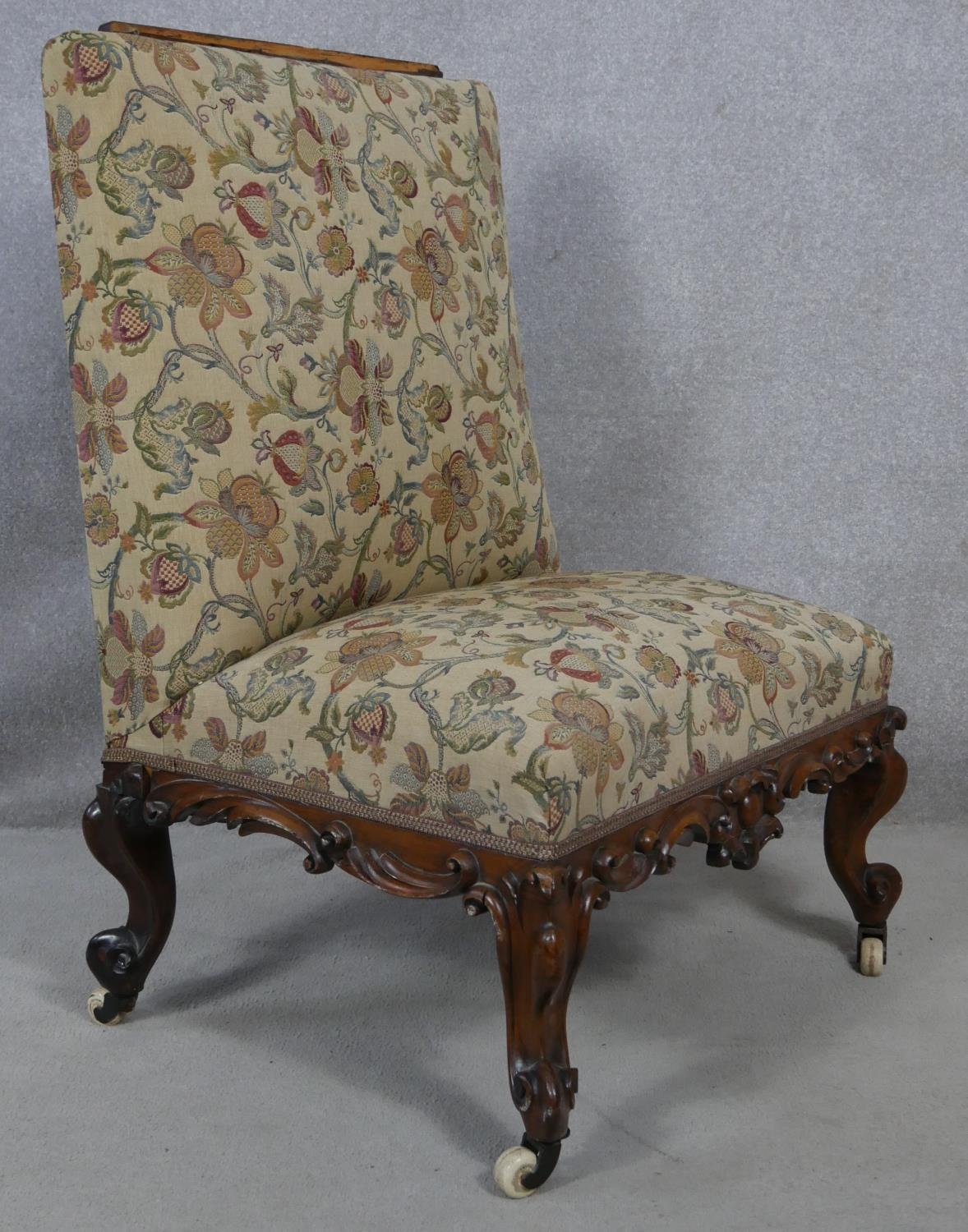 A mid Victorian carved mahogany nursing chair in floral upholstery on cabriole supports. H.110cm - Image 2 of 5