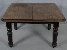 A Victorian mahogany extending dining table on tapering fluted supports. H.64 L.106 W.104cm (