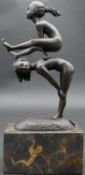 A bronze figure group, children playing leapfrog with impressed mark, raised on marble base. H.28cm