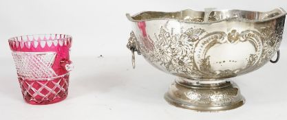 A large silver plate repousse punch bowl and ladle and a cranberry glass cut to clear ice bucket