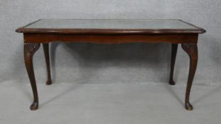 A Georgian style mahogany coffee table with inset plate glass top and tooled leather insert on