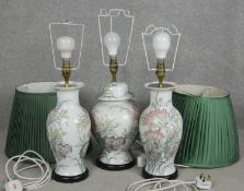 A pair of floral glazed table lamps along with a matching lamp in the form of a temple jar. H.58cm