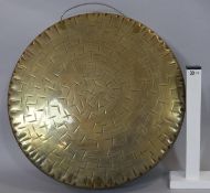 A large Oriental hammered brass gong with carrying handle. D.45cm