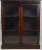 A vintage mahogany bookcase with glazed doors on plinth base. H.101 W.82 D.27cm