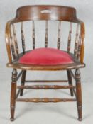 A late 19th century oak captain's desk chair with spindle back on stretchered supports. H.76cm