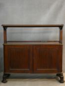 A William IV mahogany buffet cabinet with galleried upper tier above base with panel doors resting