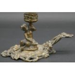 A C.1900 cast brass chamber stick of cast young faun holding a flower with basket at his feet, the