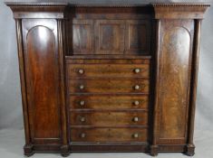 A mid 19th century mahogany compactum wardrobe with central drawers flanked by hanging sections on