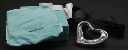 A Tiffany & Co Silver heart belt buckle by Elsa Peretti, with black leather belt. Belt and buckle