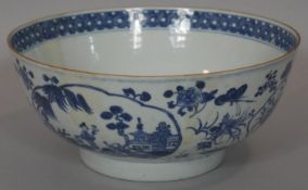 A blue and white 18th century Chinese style porcelain bowl with unglazed foot and oval panels