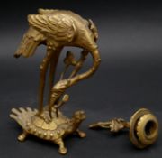 A Meiji period Japanese gilt bronze candle stick in the form of a Manchurian crane standing on a