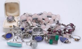 A collection of silver and gemset jewellery. Including twelve rings, some set with gemstones, a rose