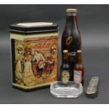 A collection of advertising items. Including a unopened limited edition Blak metal Coca Cola bottle,