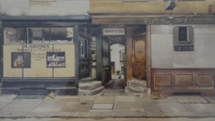Phyllis Dimond- A framed and glazed print of a shop front, printed signature. H.32 W.41.5cm
