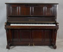 A Boyd of London mahogany cased upright piano with maker's mark to the iron frame. H.131.5 W.148 D.