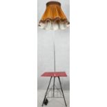 A vintage metal framed lamp standard with laminated occasional table and magazine rack to the